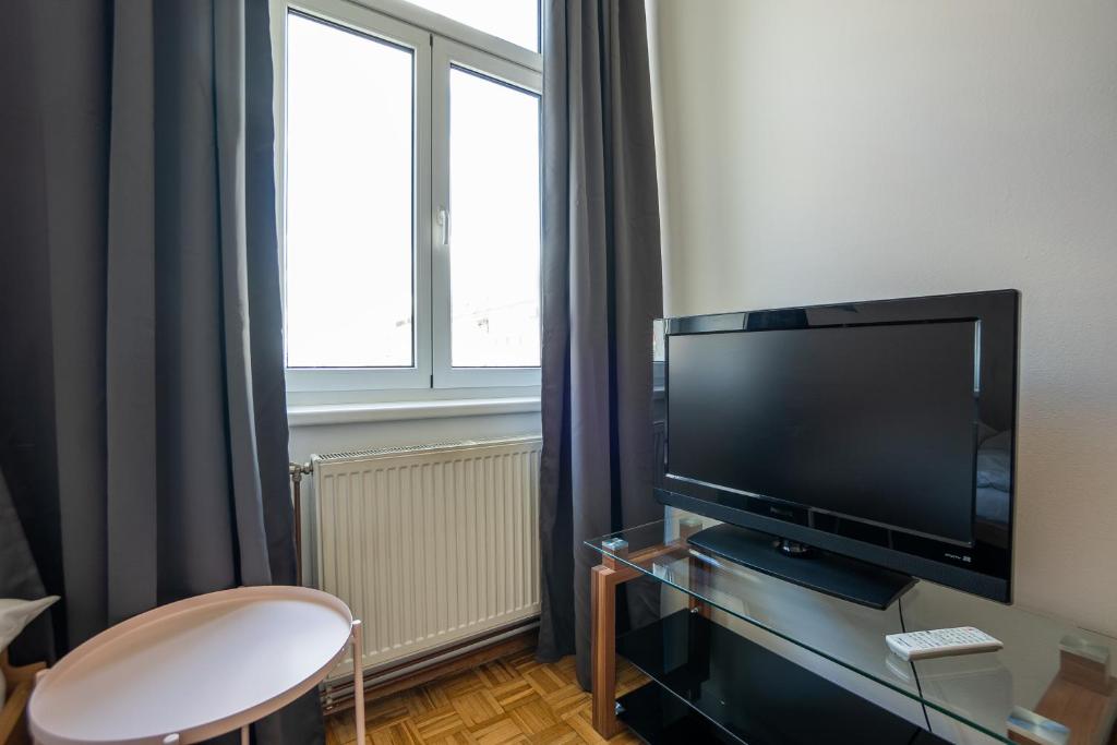 A television and/or entertainment centre at Two bedrooms family nice apartment