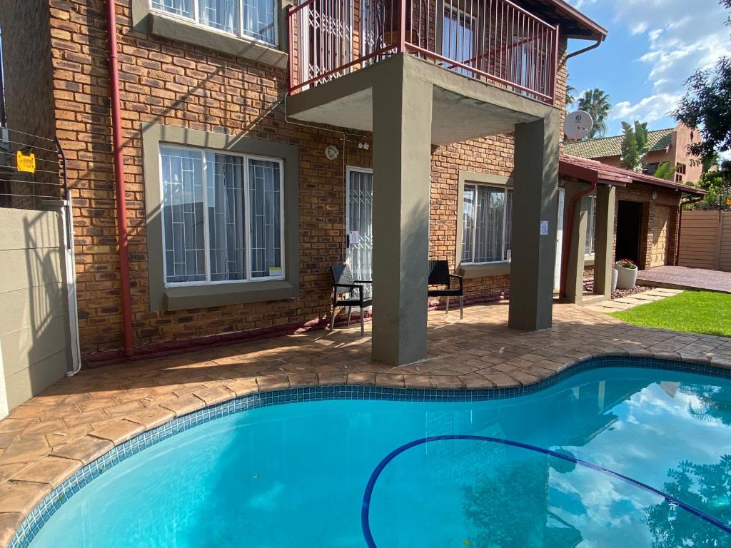 a swimming pool in front of a house at Christa's Place 899 in Pretoria