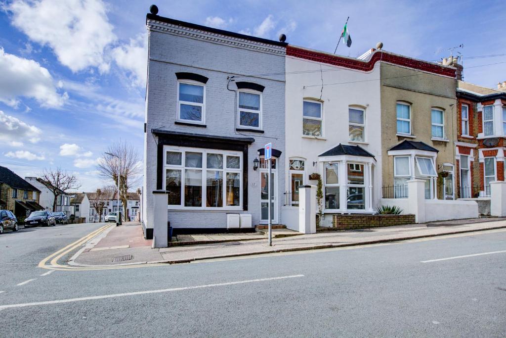 a white building on the side of a street at Pass the Keys City Beach flat next to the sea sleeps up to 6 in Southend-on-Sea