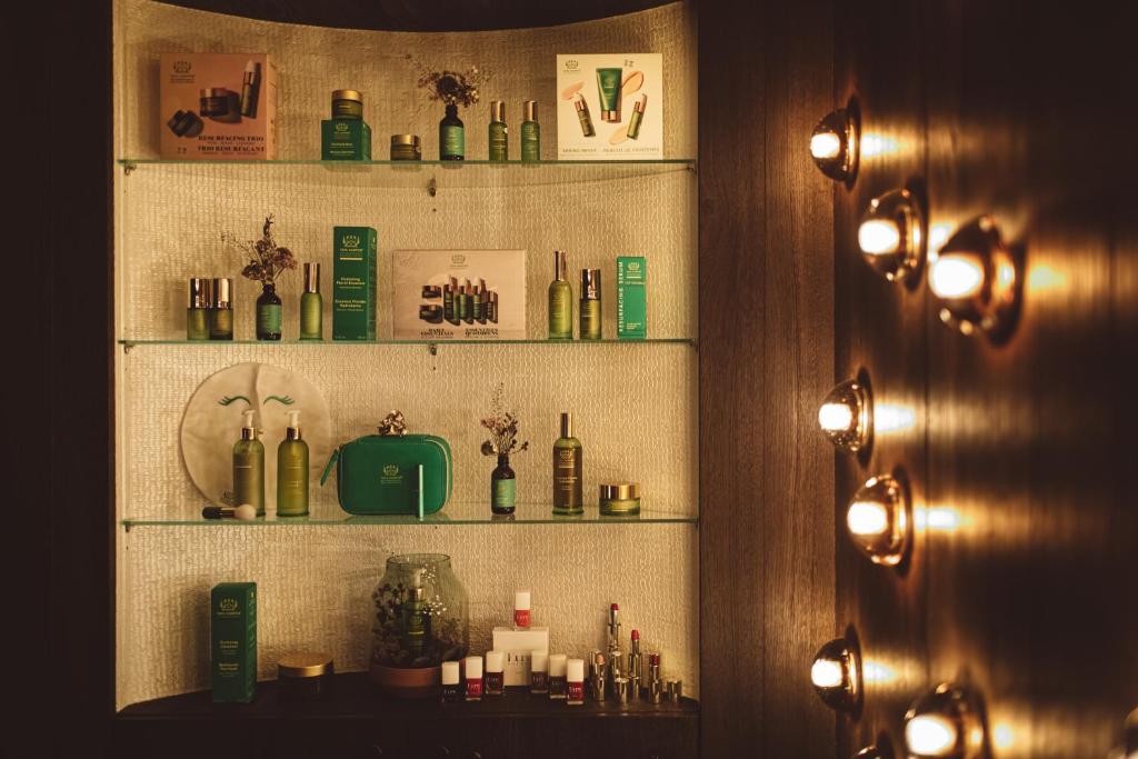 a shelf filled with bottles on a wall at Coeur de Megève in Megève