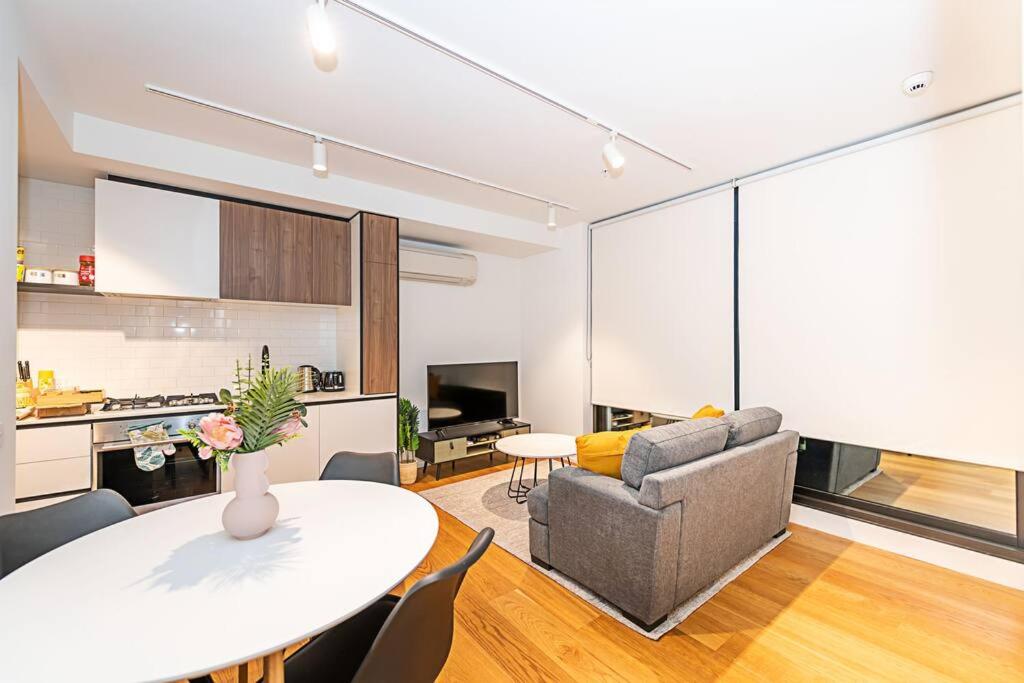 a living room with a table and a couch at Relaxing Urban Oasis in Melbourne