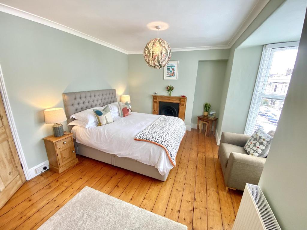 a bedroom with a bed and a couch at Spacious, seaside, Victorian home "Bay View Terrace", Penzance in Penzance