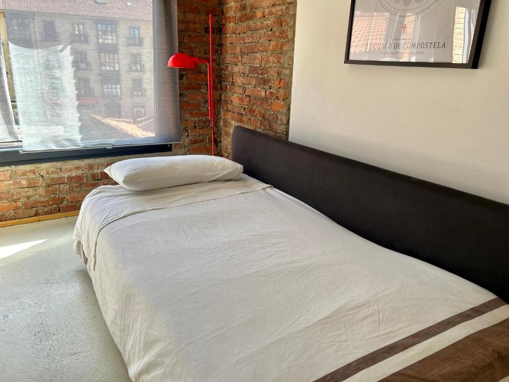 A bed or beds in a room at Suites La Catedral