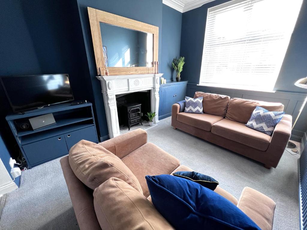 a living room with a couch and a television at House in Manchester in Manchester