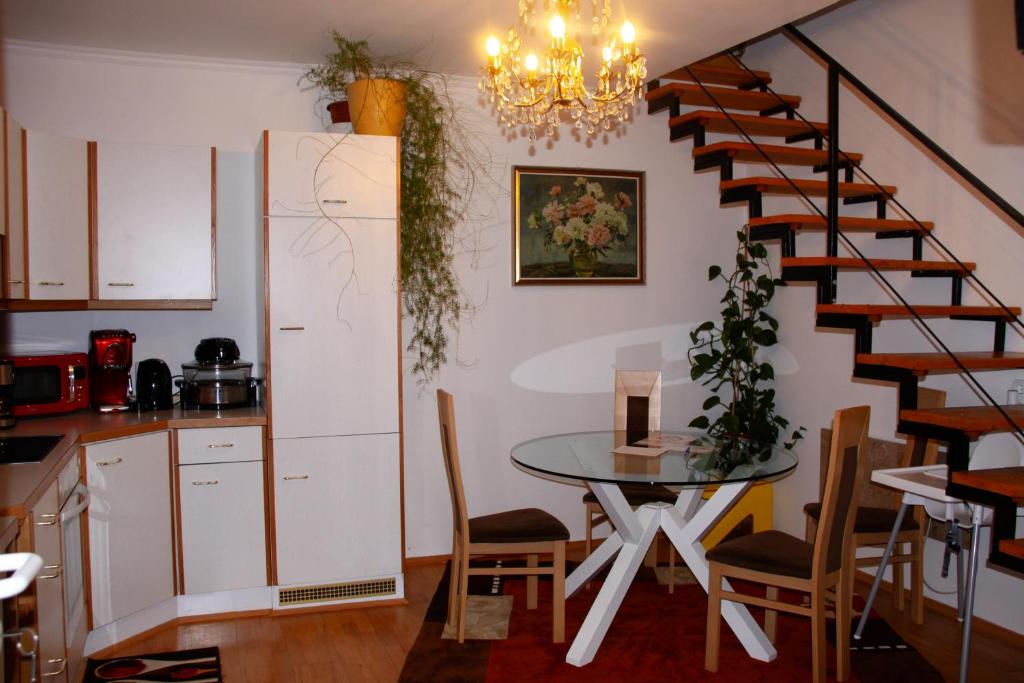 cocina y comedor con mesa y escalera en A cozy home away from home en Bad Ischl
