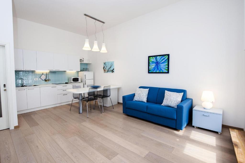 a living room with a blue couch and a table at Apartment Al Porto in Rovinj