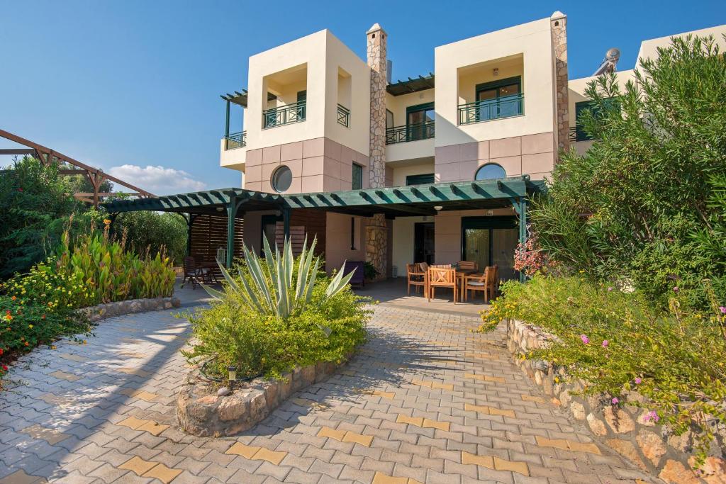 a house with a patio and a table in front of it at THERETRA KIOTARI VILLAS in Gennadi
