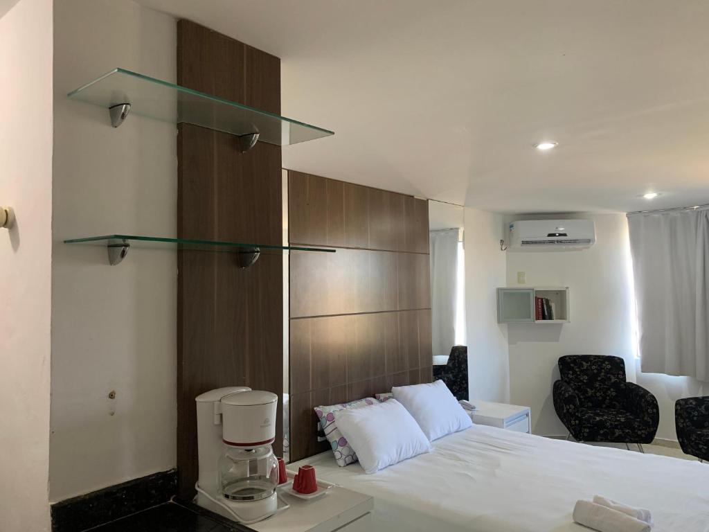 a hotel room with a bed and a coffee maker at Hotel Victory flat in Cabedelo