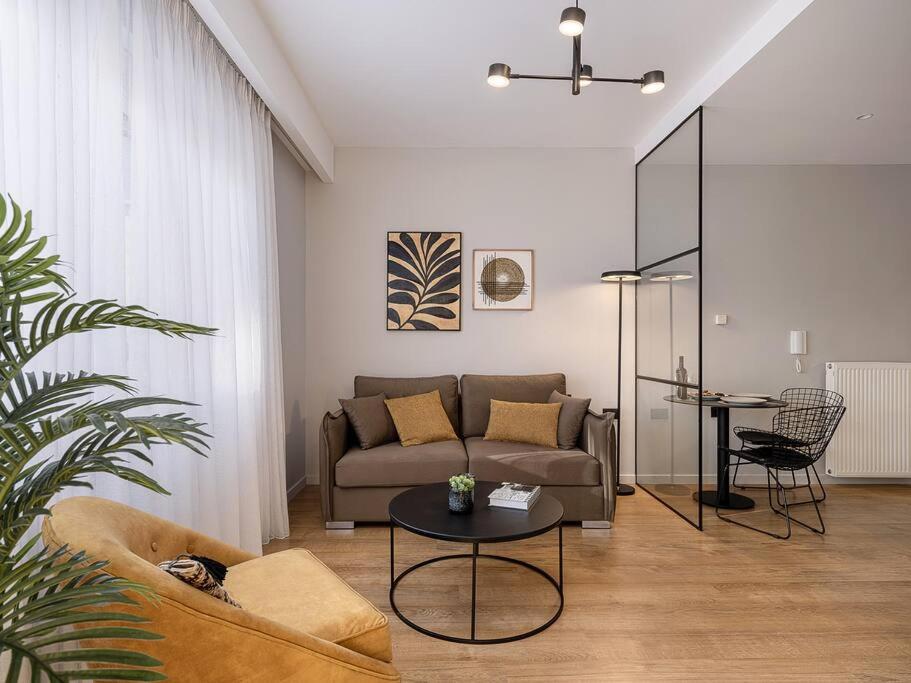 a living room with a couch and a table at Marita Luxury Apartment with parking space in Chania