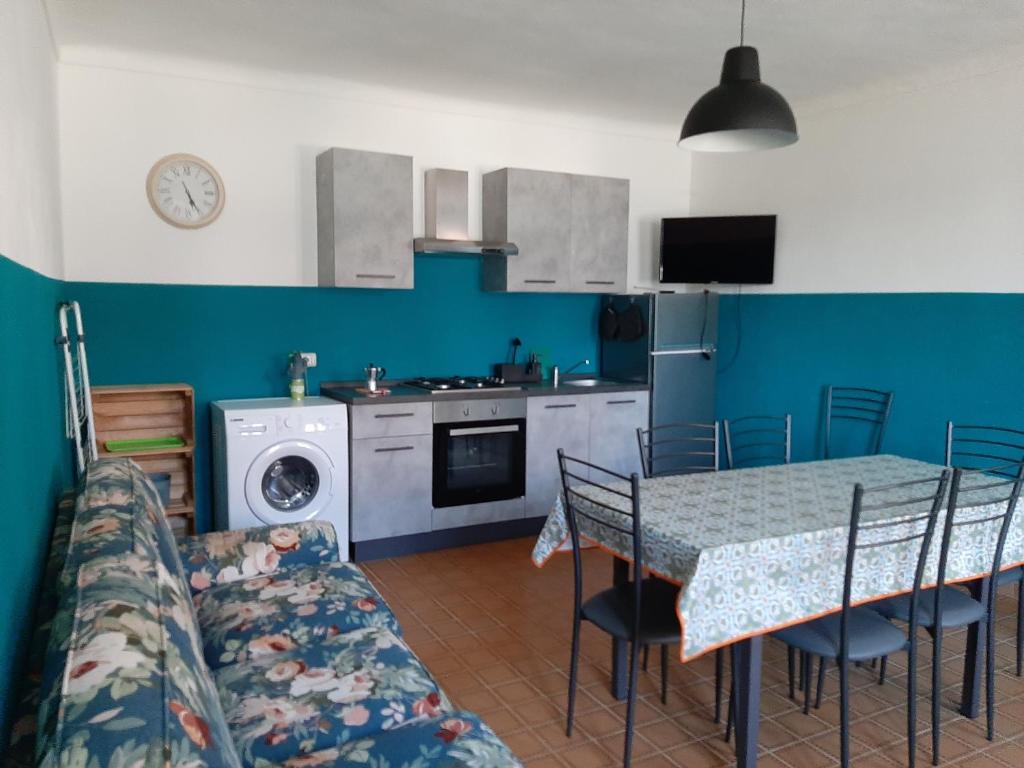 eine Küche und ein Esszimmer mit einem Tisch und einem Sofa in der Unterkunft CASA FRIDA in Canelli