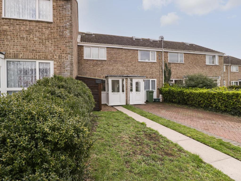 a brick house with a driveway in front of it at Lodmoor House in Weymouth