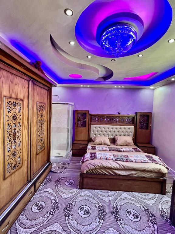 a bedroom with a bed and a purple ceiling at Wadi rum village bed and breakfast in Wadi Rum