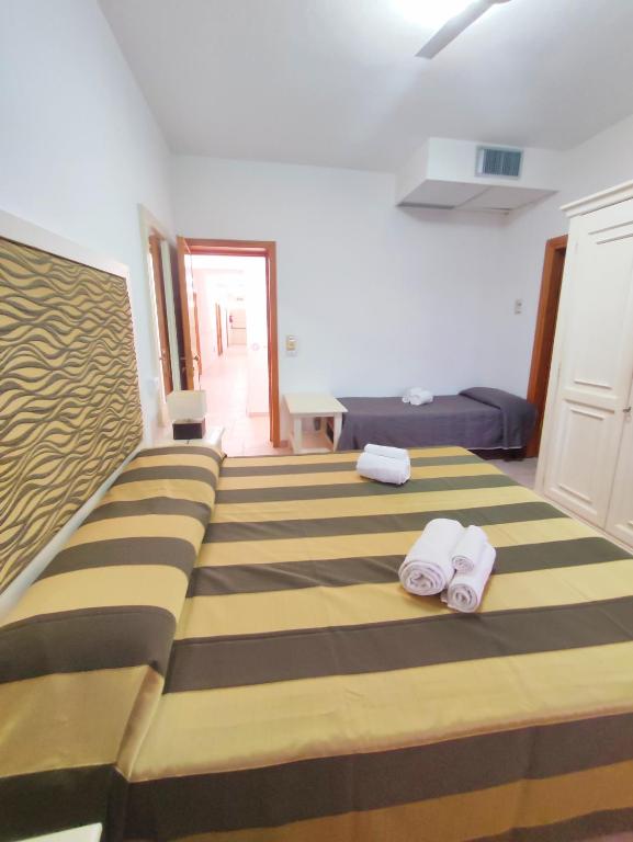 Postel nebo postele na pokoji v ubytování A.I.R. Hotel Gabbiano