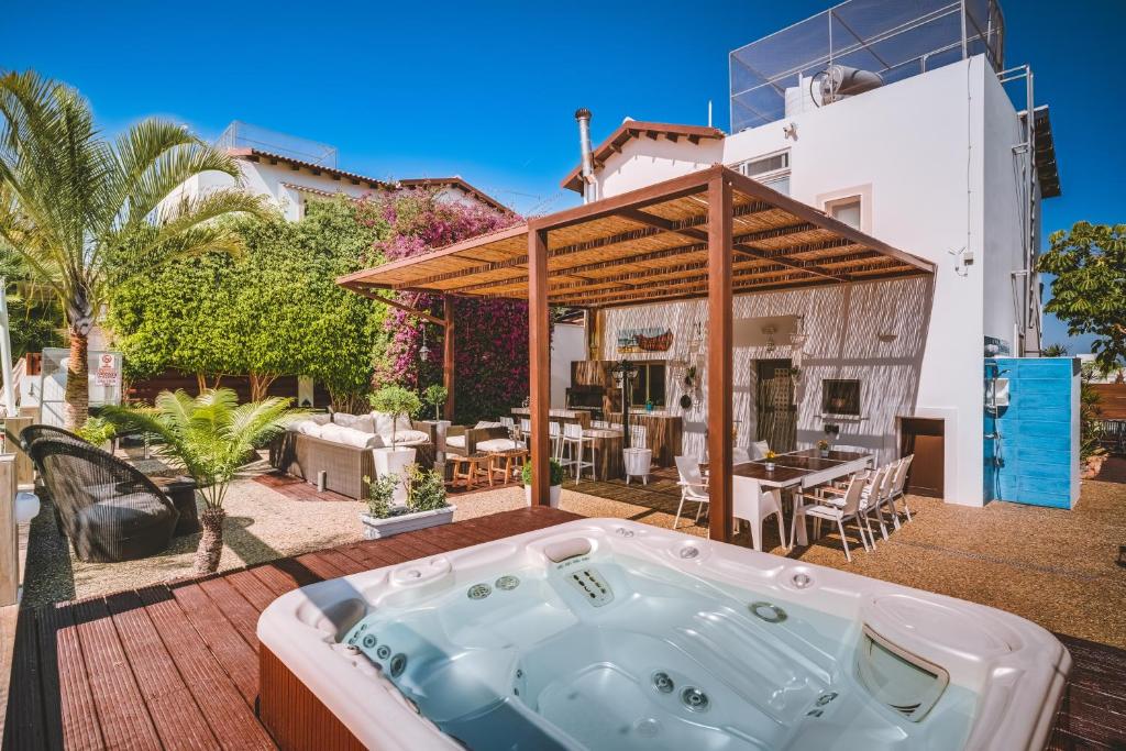 een jacuzzi op het terras van een huis bij SunnyVillas: 4BR Villa☆Private Pool + Jacuzzi - Villa Amelie in Protaras