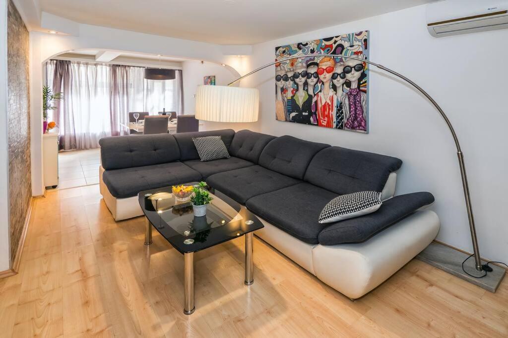 a living room with a couch and a table at Spacious 2BD, fully equipped for a relaxing holiday in Split