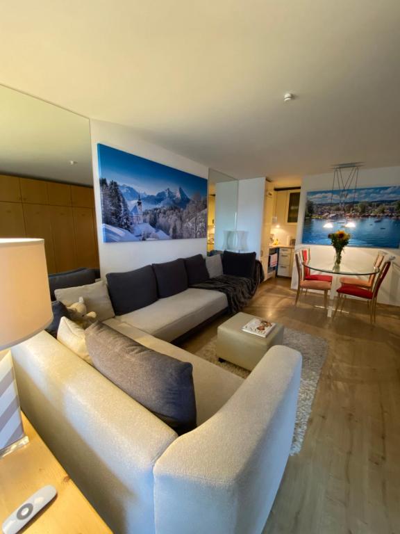 a living room with a couch and a table at Dreisessel Dreiländereck Pool Sauna in Neureichenau
