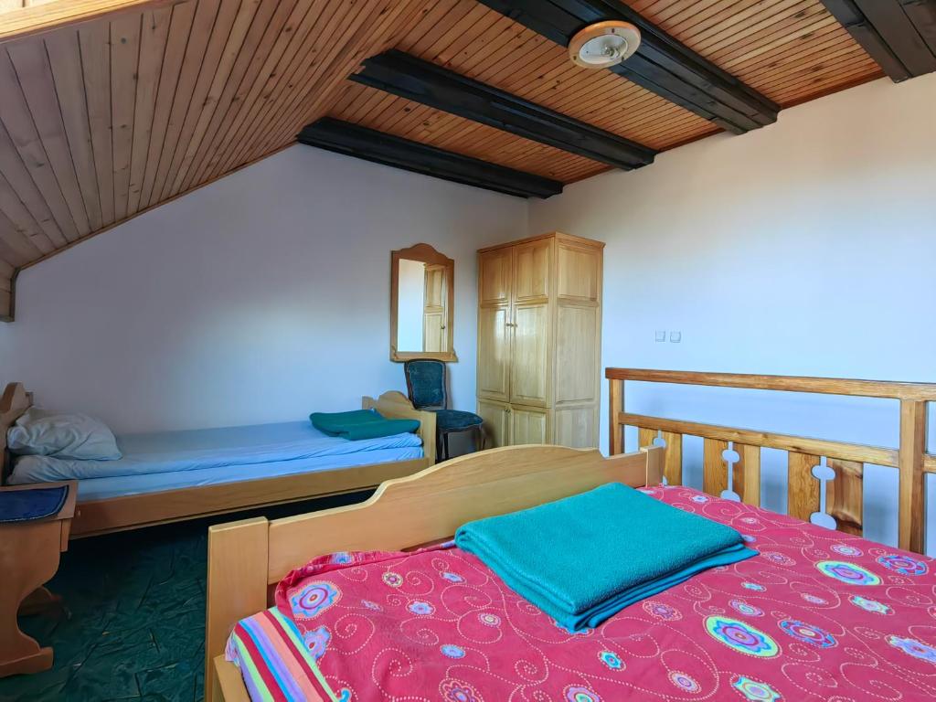 a bedroom with a large bed with a red blanket at Zlatiborski Kutak in Zlatibor