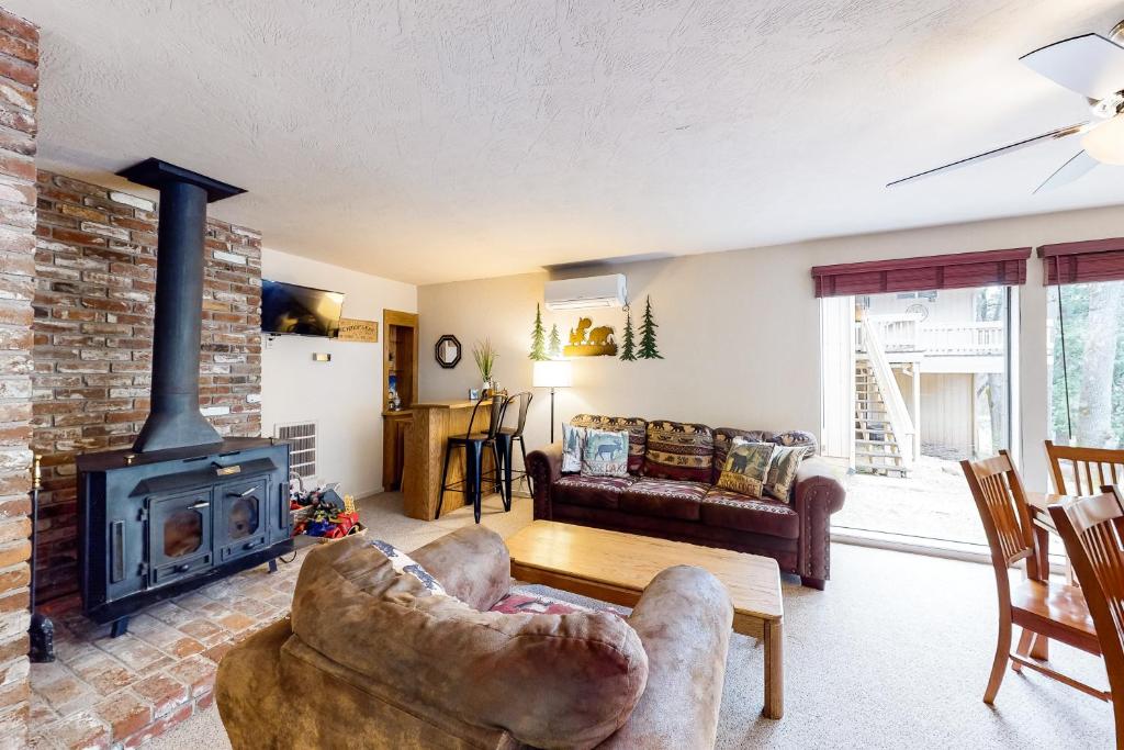 a living room with a fireplace and a couch at Creekside Cabin in Groveland