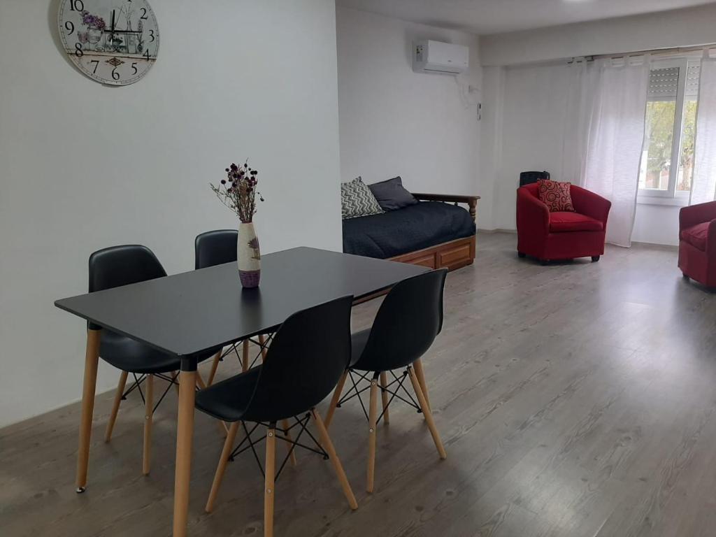 a dining room table and chairs in a living room at DEPARTAMENTO CÉNTRICo LUJÀN 2 in Luján