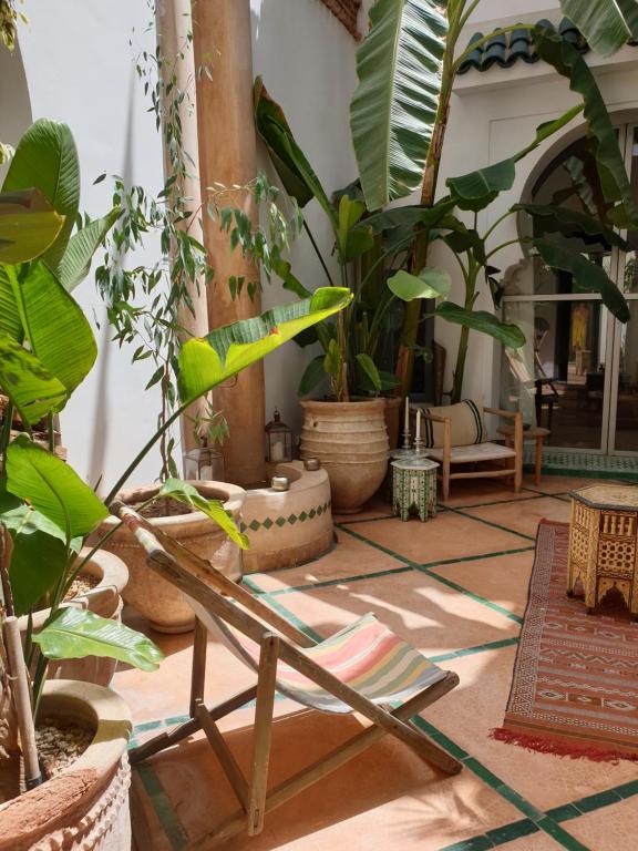 a room filled with lots of plants and a chair at RIAD EN EXCLUSIVITE SUITE MEDINA BY DO in Marrakesh