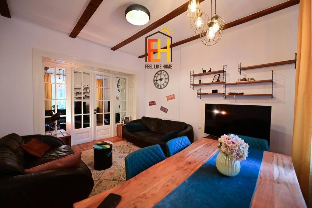 a living room with a wooden table and a couch at FLH - Zen Apartment in Sibiu