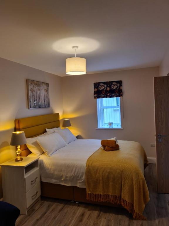 a bedroom with a large bed and a window at The Manor Guest Accommodation in Dungiven