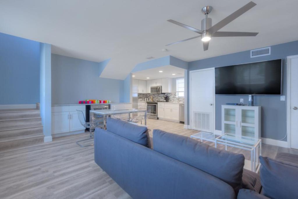 a living room with a blue couch and a tv at A Wave From It All Oceanview 2nd Level Patio in Jacksonville Beach