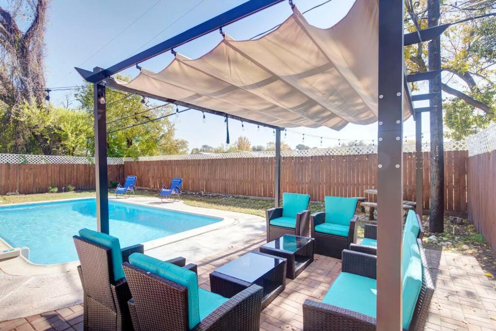 a patio with chairs and a swimming pool at Good Vibes 4 Bedroom with Private Pool, Close to Houston Loop in Houston