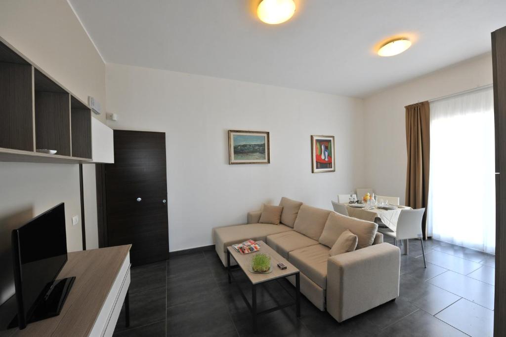 a living room with a couch and a table at Case Mistretta in Altavilla Milicia