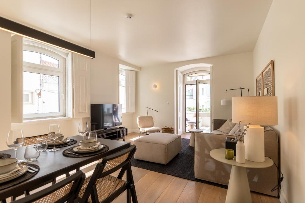 a living room with a table and a couch at Villa Sofia Cascais in Cascais
