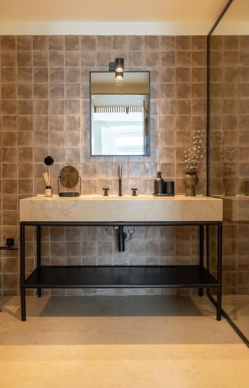 a bathroom with a sink and a mirror at Villa Sofia Cascais in Cascais