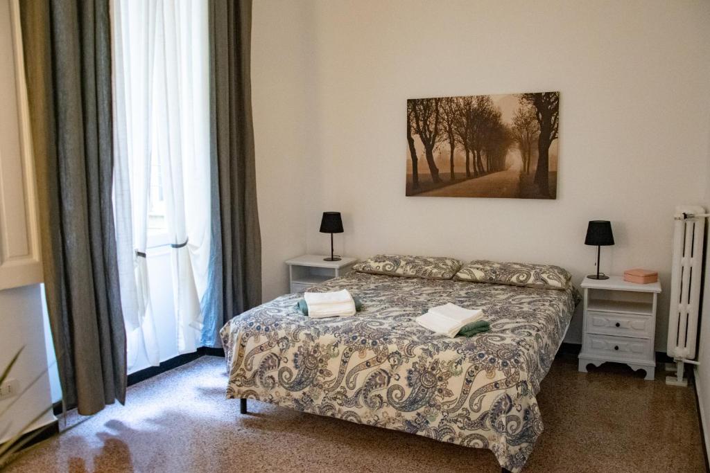 a bedroom with a bed and a painting on the wall at bocca di lupo in Genova