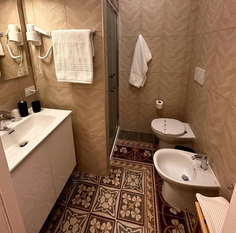 a bathroom with a sink and a toilet and a shower at M.Mansion in San Giovanni Rotondo