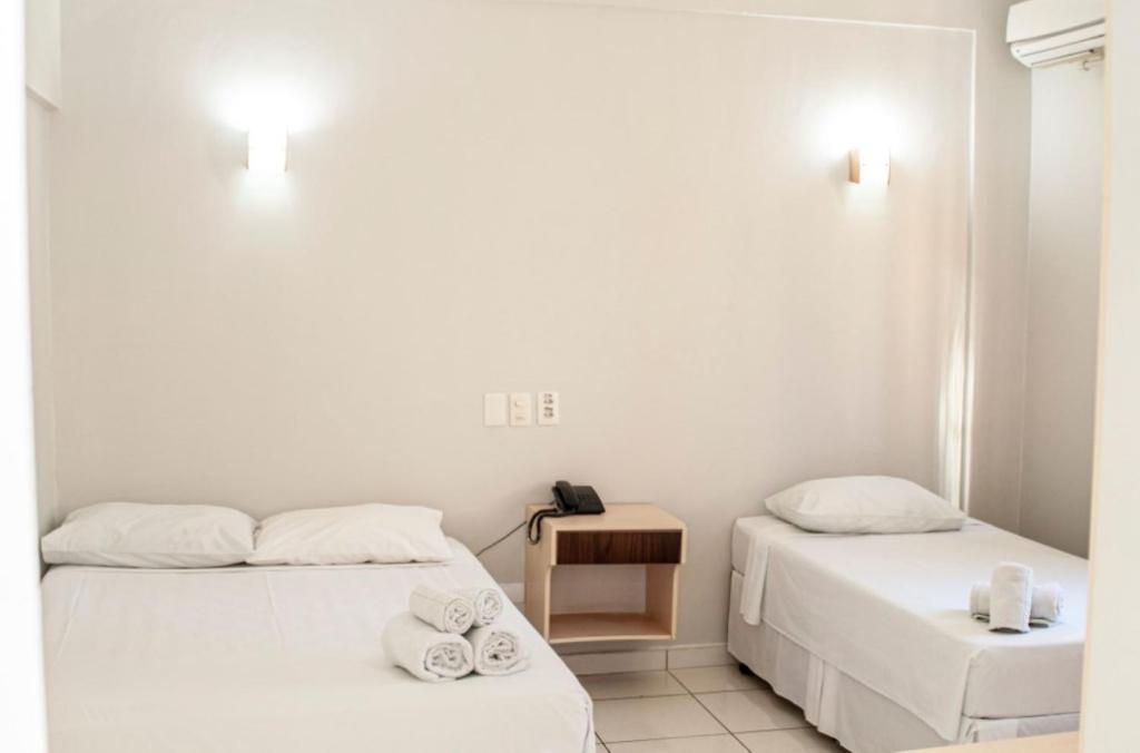 Postel nebo postele na pokoji v ubytování SMART IGUASSU HOTEL