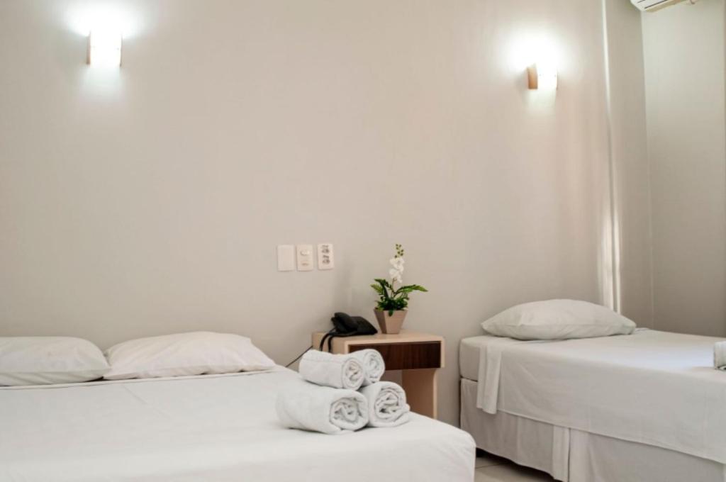 Postel nebo postele na pokoji v ubytování SMART IGUASSU HOTEL