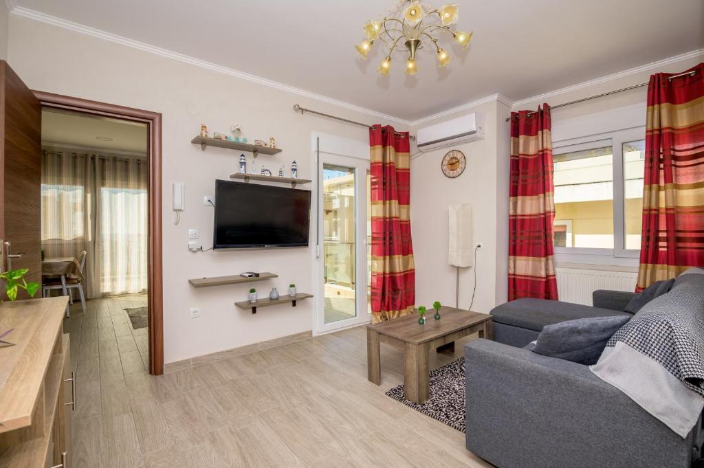 a living room with a couch and a tv at Spartacus Apartment in Alexandroupoli