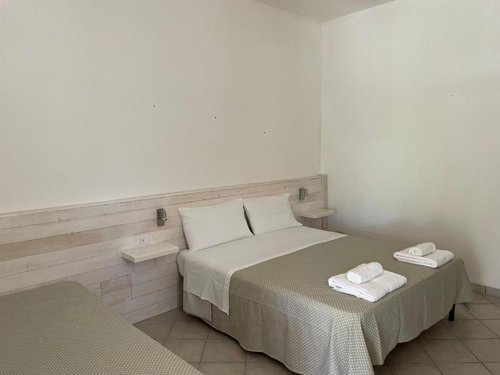 a bedroom with a bed with two towels on it at Agriturismo Terra Rossa in Otranto