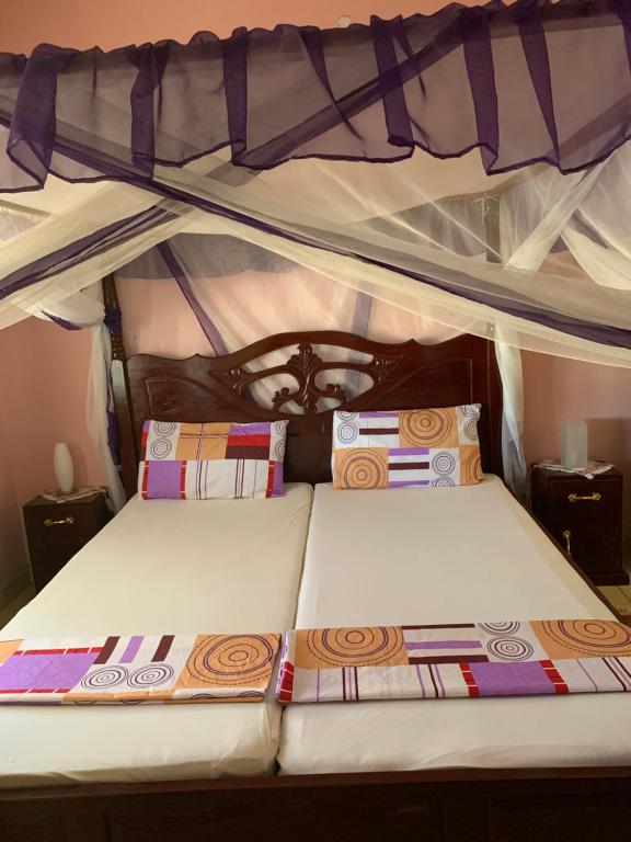 a bed with two pillows on top of a bunk bed at ZURI Homestay WIFI & Ocean BREEZE !! in Mombasa