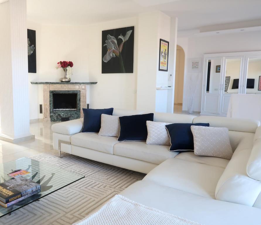 a living room with white furniture and a fireplace at Lux 180sqm flat - entire last floor in Milan