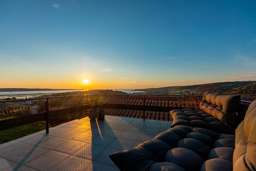 a view of the sunset from the balcony of a house at LaraBella Salt fields view studio in Portorož