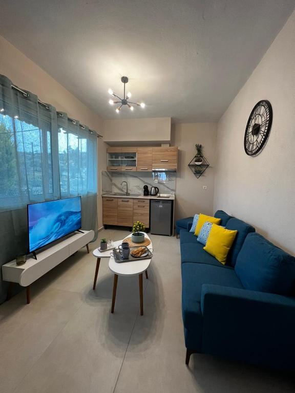 a living room with a blue couch and a table at Veni's Apartments in Potos