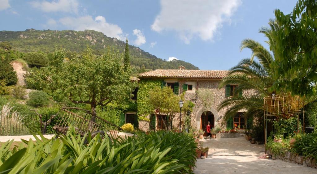 
a large stone building with trees and shrubbery at Hotel Sa Vall in Valldemossa
