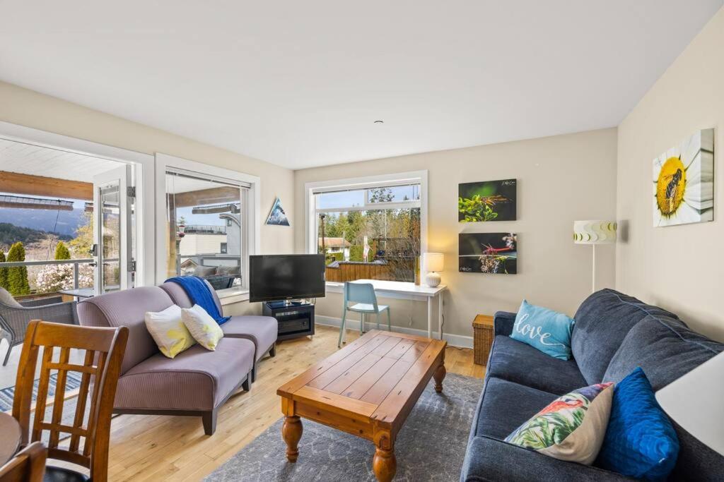 a living room with a couch and a table at A Peaceful Suite Stay in Brentwood Bay