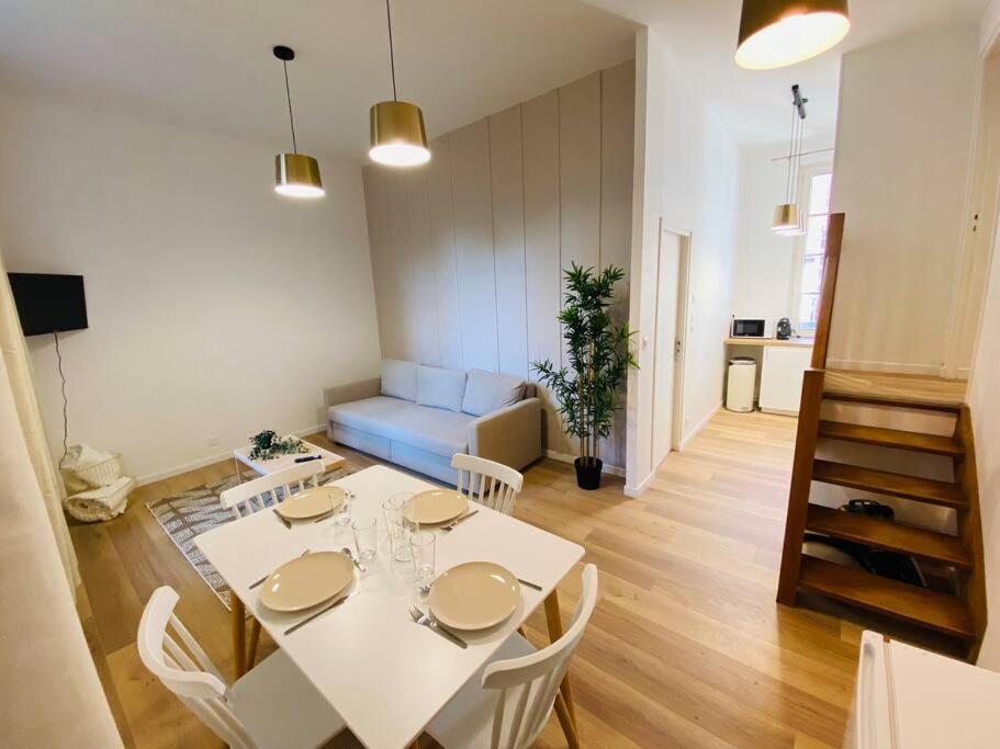 une salle à manger avec une table et des chaises blanches dans l'établissement Les Deux Anges, à Rouen