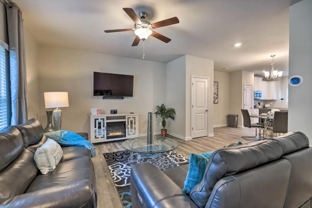 a living room with a couch and a ceiling fan at Modern Townhome 10 mins to Downtown Atlanta in Atlanta