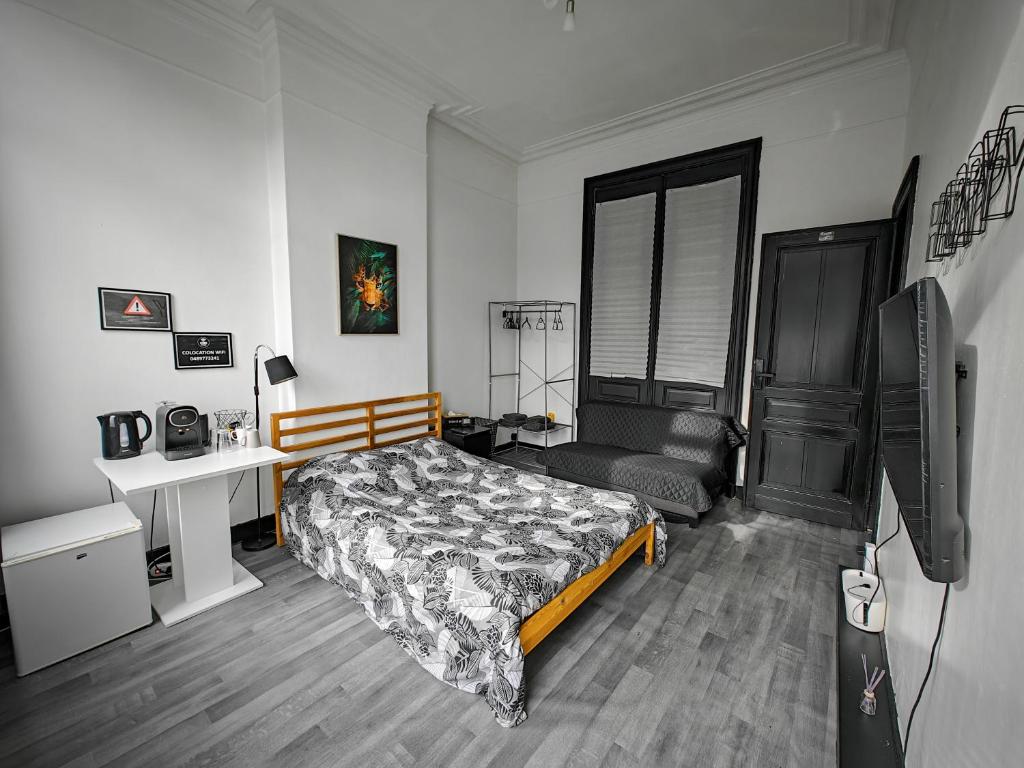 a bedroom with a bed and a desk and a television at Private Room in center of Charleroi in Charleroi