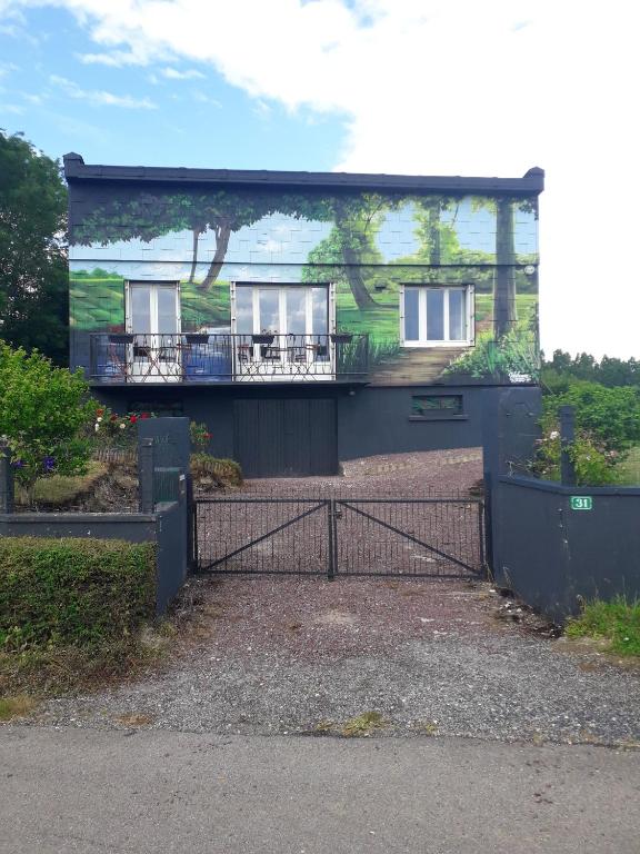 a house with a gate in front of it at Maison de 4 chambres avec jardin clos et wifi a Villers sous Foucarmont in Villers-sous-Foucarmont