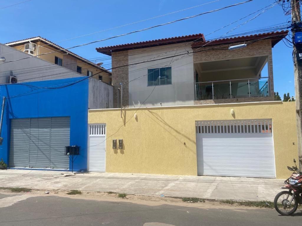 a building with two garage doors on a street at Casa dos Ventos Barreirinhas in Barreirinhas