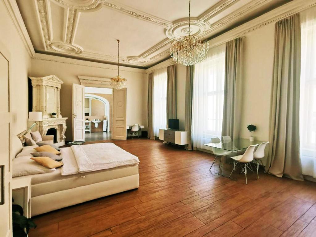 a large room with a bed and a table in it at Luxury Design City centre Apartment in Brno