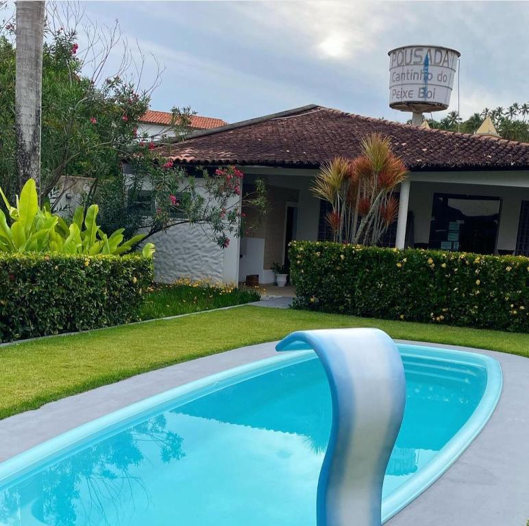 a swimming pool in front of a house at Chalés do Porto in Pôrto de Pedras